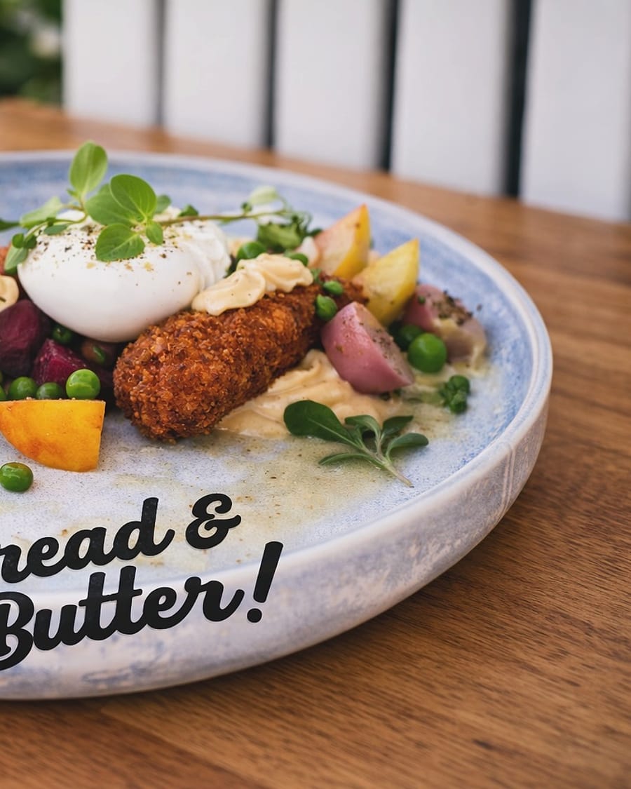 Eggs benedict with fritters on a Bread and Butter plate