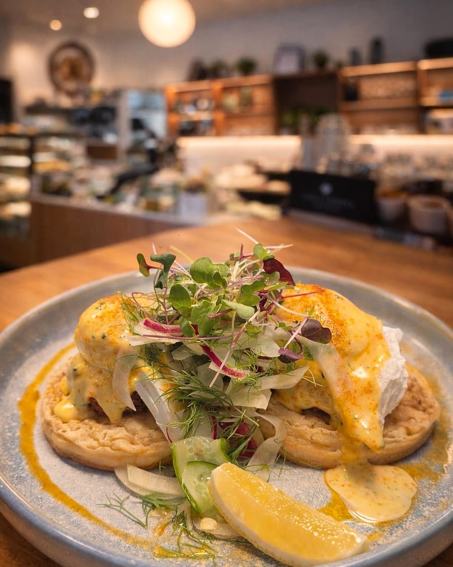 Eggs benedict on a crumpet with hollandaise and microgreens