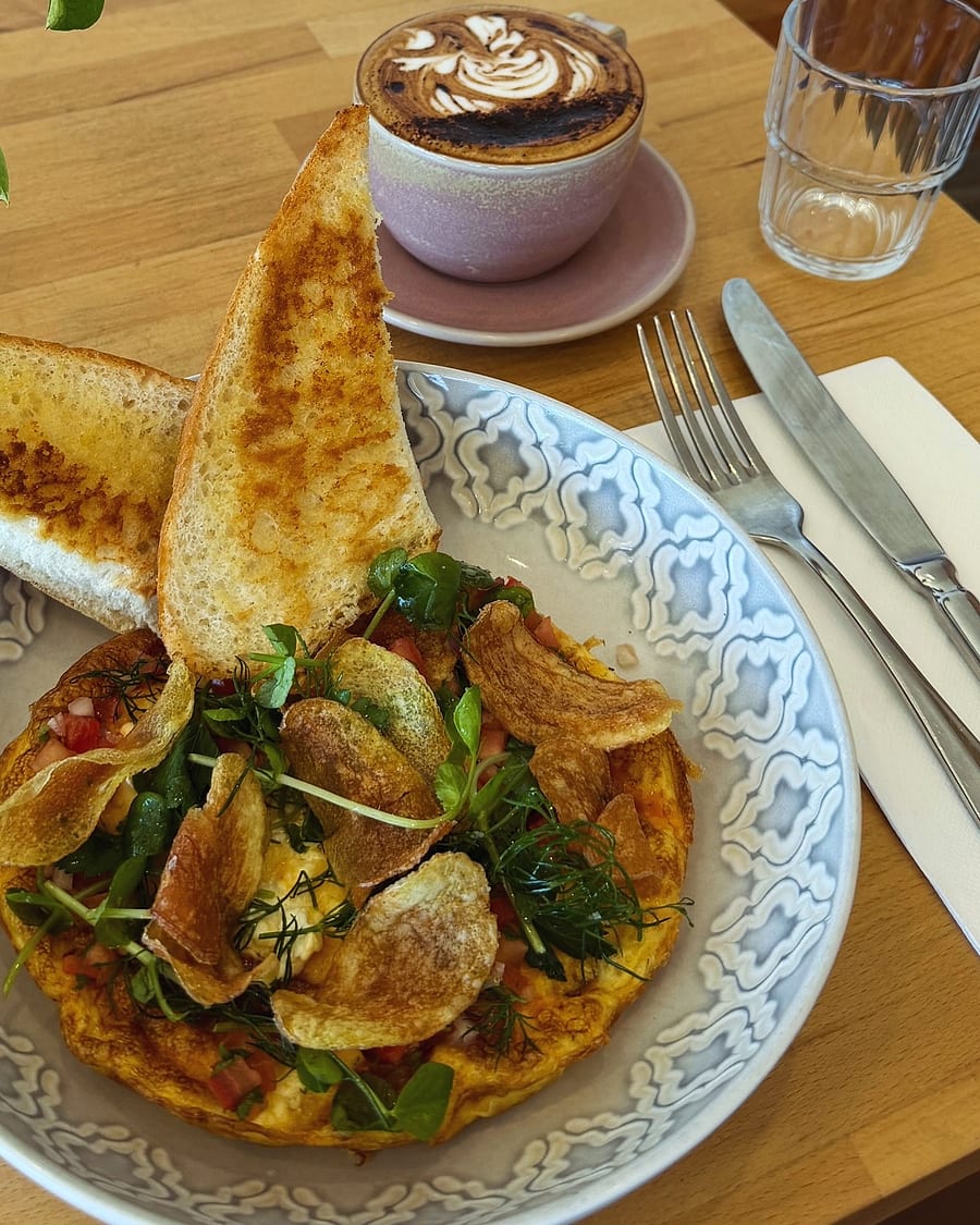 A curry bowl with roasted potatoes, toast and a fried egg