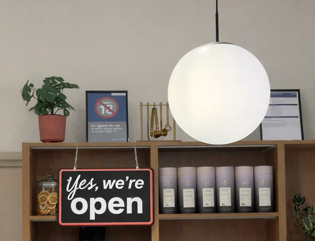 Inside Bread and Butter: pendant light, shelves of Toby's Estate coffee and a yes we're open sign